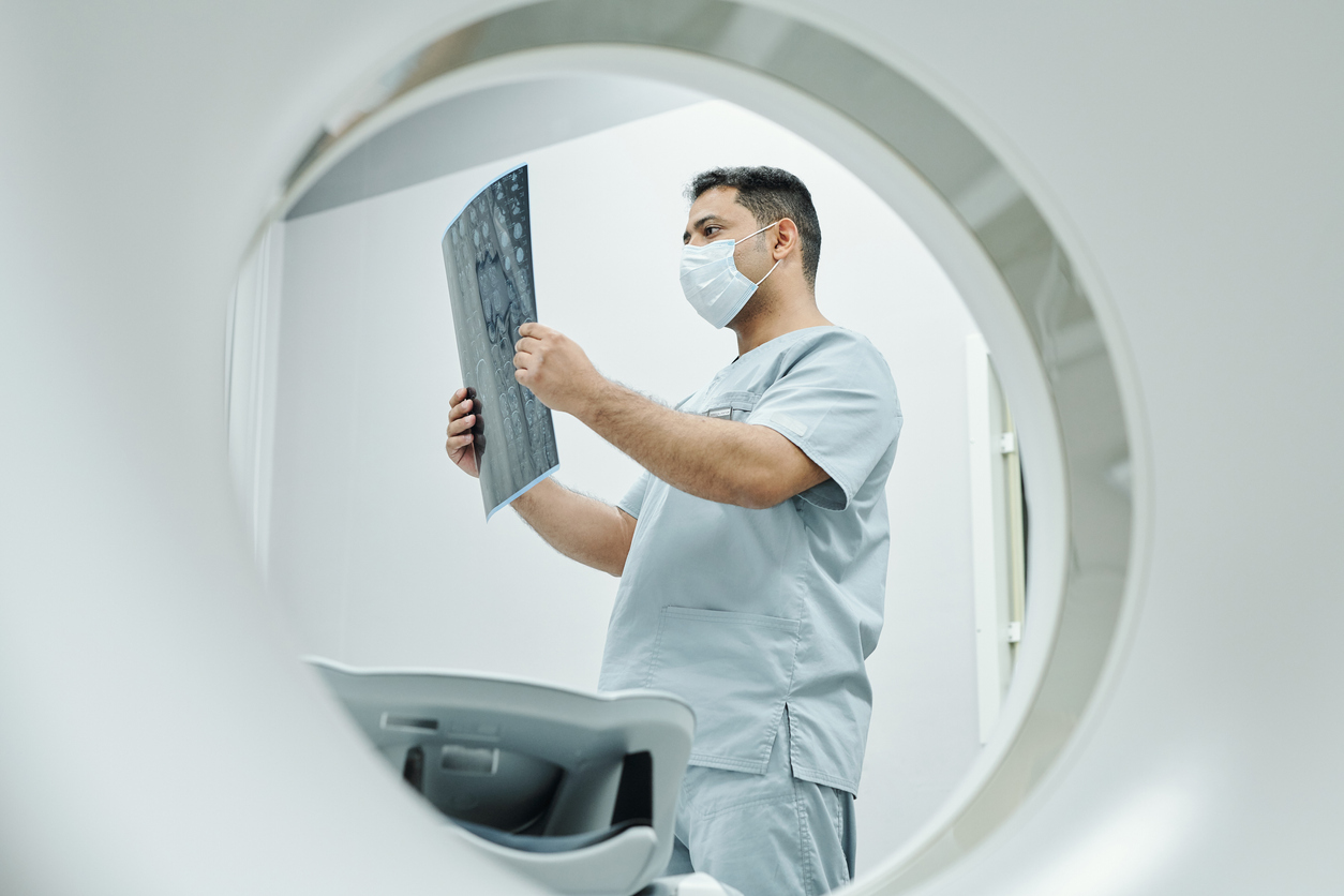 doctor looking at prostate cancer PSMA PET/CT scan