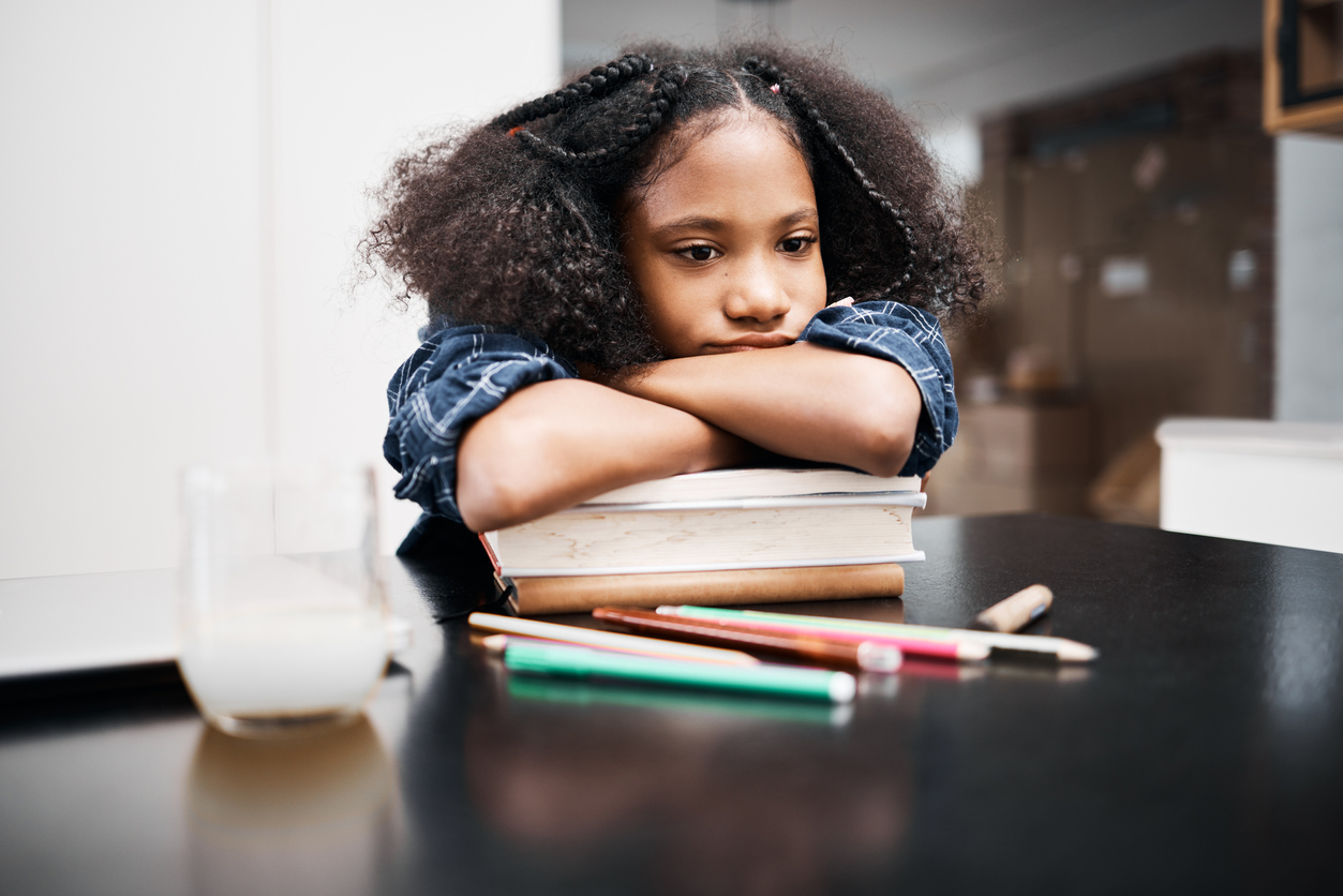 Girl with ADHD resting on schoolbooks