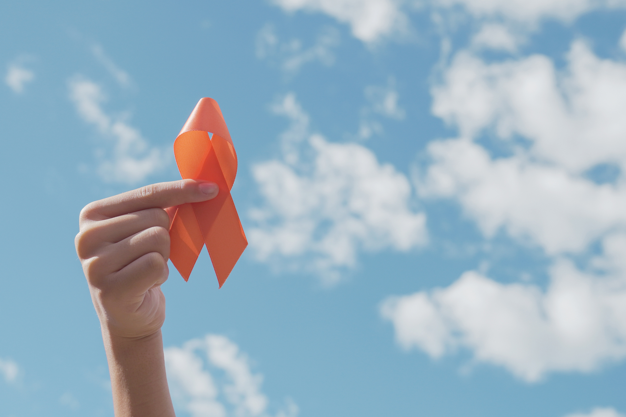 Hand holding cancer awareness ribbon