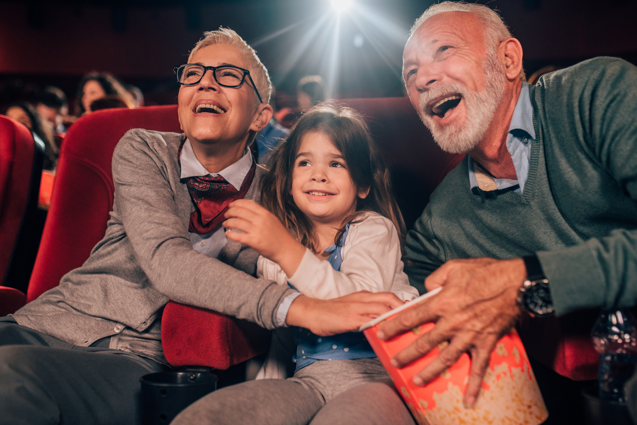 Grandparents at the movies with young grand child