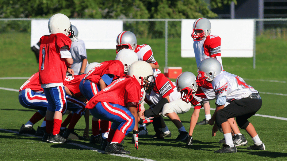 Youth football injury prevention through proper technique training with helmets and protective gear