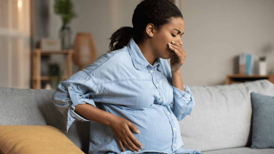 Expectant mother feeling nauseous from morning sickness during pregnancy