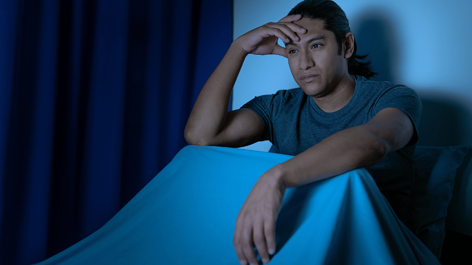 Man awake at night, unable to sleep due to frequent nighttime urination and nocturia
