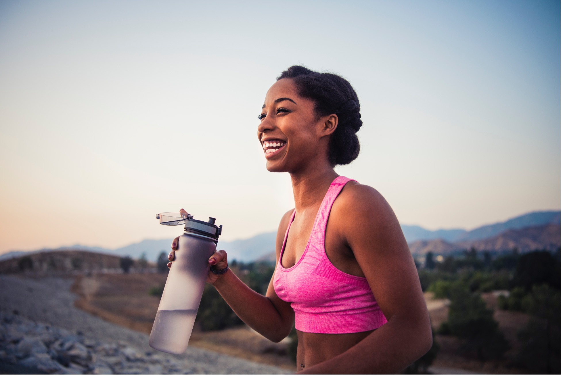 Woman smiling finishing a workout feeling confident after a plastic surgery consultation