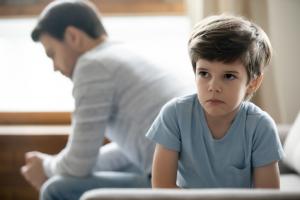 Child with oppositional defiant disorder sitting and staring after fighting with his father