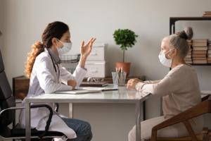 A female doctor explaining ovarian cancer to an elderly patient