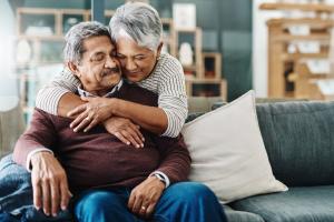 Elderly couple embracing after aphasia diagnosis