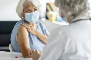 Elderly woman with doctor after getting flu shot