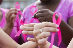 Group of women holding pink breast cancer awareness ribbons