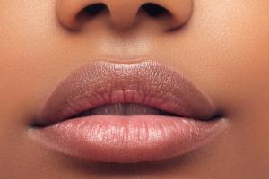 Part of woman's face. Woman's lips and nose. Soft skin