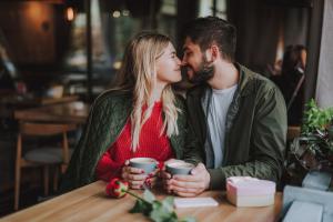 Couple expressing love by touching noses at a coffee shop