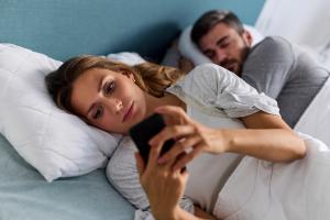Woman suffering from low libido ignoring partner in bed