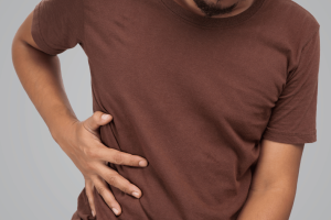 Man experiencing severe gallbladder pain in the upper abdomen