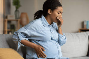 Expectant mother feeling nauseous from morning sickness during pregnancy