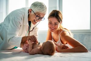 Mother and doctor examining a baby