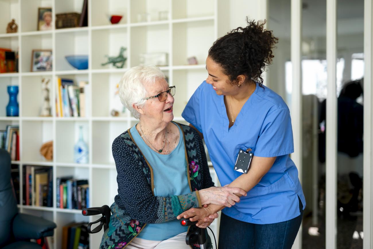 Nurse helping an elderly patient in her home