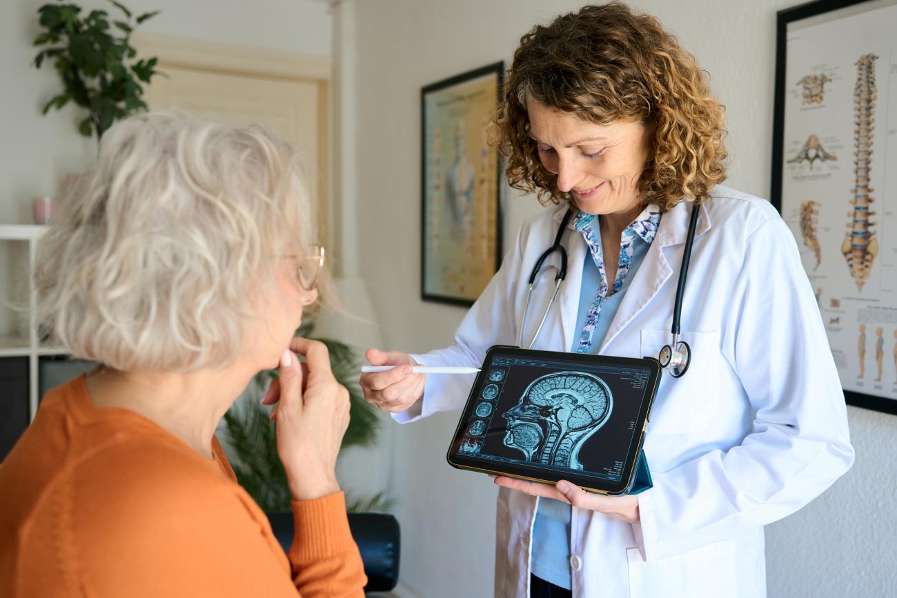 Neurologist discussing brain mri scan with senior patient