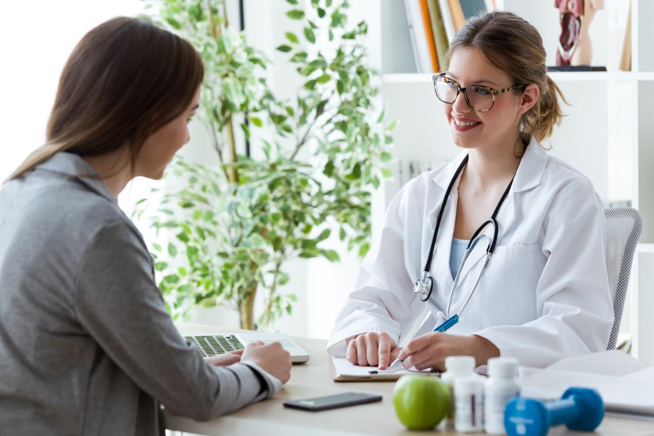 Young woman talking with dietician about her health