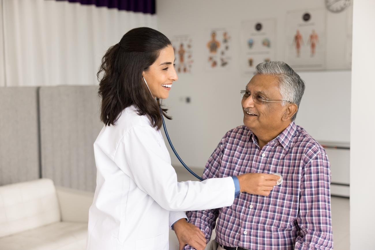 Female cardiologist examines a mature man at cardiology office