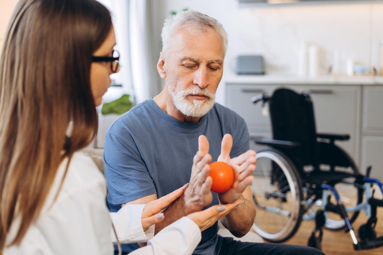 Senior man receiving occupational therapy for hand rehabilitation